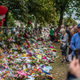 People view flowers and tributes by the botanical gardens on March 19, 2019 in Christchurch, New Zealand